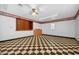 Basement with checkerboard floors, white walls, and built-in storage cabinets at 3263 S Jim Minor Rd Rd, Haw River, NC 27258