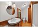 Bathroom featuring a wood vanity, mirror, toilet and a wood trimmed window at 3263 S Jim Minor Rd Rd, Haw River, NC 27258