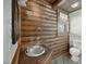 Cabin bathroom featuring a sink and vanity, toilet, window and wood walls at 3263 S Jim Minor Rd Rd, Haw River, NC 27258