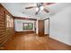 Spacious bedroom with hardwood floors, wood-paneled accent walls and a ceiling fan at 3263 S Jim Minor Rd Rd, Haw River, NC 27258