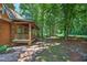 Log cabin with a charming covered porch and brick walkway at 3263 S Jim Minor Rd Rd, Haw River, NC 27258