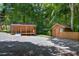 Property featuring wooden cabins on a gravel lot surrounded by lush trees at 3263 S Jim Minor Rd Rd, Haw River, NC 27258