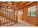 Interior log cabin foyer featuring wood walls, a wooden staircase, and tile flooring at 3263 S Jim Minor Rd Rd, Haw River, NC 27258