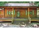 Log cabin style home with a cozy covered front porch and inviting entrance at 3263 S Jim Minor Rd Rd, Haw River, NC 27258