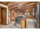 A full kitchen with wood-paneled walls, stainless steel appliances, and an open layout at 3263 S Jim Minor Rd Rd, Haw River, NC 27258