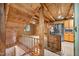 A view looking from an upstairs landing into a large living room and the kitchen at 3263 S Jim Minor Rd Rd, Haw River, NC 27258