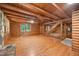 Spacious log cabin living room with wood floors, a ceiling fan, an open staircase and log walls at 3263 S Jim Minor Rd Rd, Haw River, NC 27258