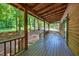 Spacious covered porch with wood flooring and exposed beam ceiling at 3263 S Jim Minor Rd Rd, Haw River, NC 27258