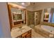 Bathroom with a large vanity, framed mirrors, a bathtub, and a shower with glass doors at 332 Bridgegate Dr, Cary, NC 27519