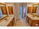 Bathroom featuring double vanities with wooden cabinets and framed mirrors at 332 Bridgegate Dr, Cary, NC 27519