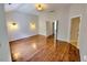 Spacious bedroom with wood flooring, vaulted ceiling, a modern light fixture and ensuite door, with natural light at 332 Bridgegate Dr, Cary, NC 27519