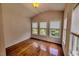 Bright room with hardwood floors, vaulted ceiling, and three windows overlooking the backyard at 332 Bridgegate Dr, Cary, NC 27519