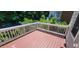 Outdoor deck showcasing its wooden surface and white railings surrounded by lush greenery at 332 Bridgegate Dr, Cary, NC 27519