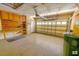 Well-organized garage featuring built-in cabinets, workbench, and space for parking or storage at 332 Bridgegate Dr, Cary, NC 27519