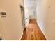 Hallway features gleaming hardwood flooring and access to the upper level and bedrooms at 332 Bridgegate Dr, Cary, NC 27519