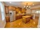 Spacious kitchen featuring stainless steel appliances, wooden cabinets, granite countertops, and a functional center island at 332 Bridgegate Dr, Cary, NC 27519