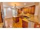 Well-lit kitchen featuring custom wood cabinetry, stainless steel appliances, and center island with granite countertops at 332 Bridgegate Dr, Cary, NC 27519