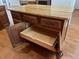 Close up of kitchen island with cabinet doors and drawers, as well as granite counter, and wood flooring at 332 Bridgegate Dr, Cary, NC 27519