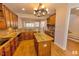 Gourmet kitchen featuring wood cabinets, stainless appliances, granite counters, and an island open to a dining area at 332 Bridgegate Dr, Cary, NC 27519