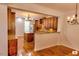 Kitchen showcasing granite countertops and dark wood cabinets with a view into the dining area at 332 Bridgegate Dr, Cary, NC 27519