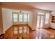 Open living space features hardwood floors, large windows, and glass doors to the outdoor deck at 332 Bridgegate Dr, Cary, NC 27519