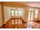 Sunlit living room featuring hardwood floors and glass doors leading to the outdoor deck at 332 Bridgegate Dr, Cary, NC 27519