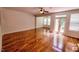 Spacious living area with hardwood floors, a ceiling fan, and glass doors leading to a deck at 332 Bridgegate Dr, Cary, NC 27519