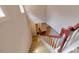 Interior shot looking down carpeted stairs with wood railings and wood-look flooring on landing at the bottom at 332 Bridgegate Dr, Cary, NC 27519
