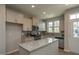 Well-lit kitchen features granite countertops, stainless steel appliances, and a functional island at 366 Church St # 58, Wendell, NC 27591