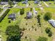 Aerial view of a home featuring a large backyard with garden beds and mature trees in a quiet neighborhood at 3831 Abattoir Rd, Angier, NC 27501