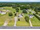 Expansive aerial view of a home with a lush green lawn, outbuildings, and surrounding trees at 3831 Abattoir Rd, Angier, NC 27501