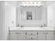 Bright bathroom featuring double sinks, a vanity, and a large mirror at 3831 Abattoir Rd, Angier, NC 27501