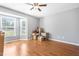 Bright bedroom with wood-look floors, ceiling fan, and bay window at 3831 Abattoir Rd, Angier, NC 27501