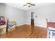 Neutral bedroom featuring wood-look floors, ceiling fan, and a laundry area in the closet at 3831 Abattoir Rd, Angier, NC 27501