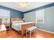 Comfortable bedroom with wood-look floors, two-tone paint, and a ceiling fan at 3831 Abattoir Rd, Angier, NC 27501