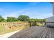 Large wooden deck with railing overlooking backyard and mature trees at 3831 Abattoir Rd, Angier, NC 27501