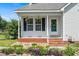 Inviting front porch with hanging plants and decorative wreath, offering a warm welcome at 3831 Abattoir Rd, Angier, NC 27501