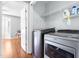 Modern laundry room with washer, dryer, and shelving for supplies at 3831 Abattoir Rd, Angier, NC 27501