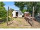 View of a backyard shed, a chicken coop, and a mature tree at 3831 Abattoir Rd, Angier, NC 27501
