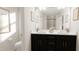 Elegant bathroom with double vanity sinks, dark cabinetry, modern fixtures, and a well-lit mirror at 40 Digging Time Ave, Princeton, NC 27569
