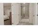 Bathroom view featuring a tiled walk-in shower, neutral color scheme, and open door view to a bedroom at 40 Digging Time Ave, Princeton, NC 27569