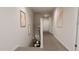 View of the hallway with neutral walls and carpeted floors, leading to the next level of the home at 40 Digging Time Ave, Princeton, NC 27569