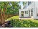 A well-kept backyard features a fence and a sunroom attached to the white house at 410 Willingham Rd, Morrisville, NC 27560