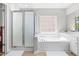 Primary bathroom features walk-in shower, large tub and double vanity at 410 Willingham Rd, Morrisville, NC 27560