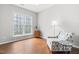 Bright bedroom features hardwood floors, a patterned accent chair, and a unique decorative window film at 410 Willingham Rd, Morrisville, NC 27560