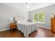 Comfortable bedroom featuring hardwood floors, a ceiling fan, and natural light at 410 Willingham Rd, Morrisville, NC 27560
