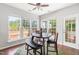 Bright breakfast nook with wood table and chairs surrounded by plenty of natural light at 410 Willingham Rd, Morrisville, NC 27560