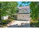 Home featuring a well-manicured lawn, beautiful landscaping, and a two-car garage at 410 Willingham Rd, Morrisville, NC 27560