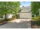 Two-story home with a well-maintained lawn, a two-car garage, and a cozy front porch at 410 Willingham Rd, Morrisville, NC 27560