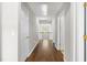Hallway featuring hardwood floors and white doors leading to various rooms at 410 Willingham Rd, Morrisville, NC 27560